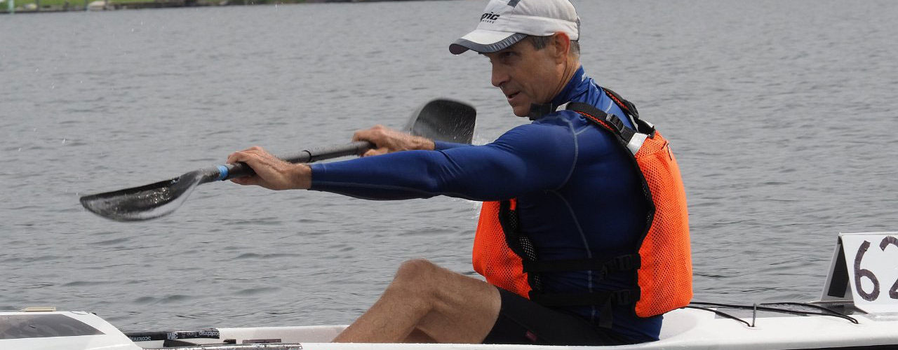Man with razor-sharp focus paddles his surfski with precision